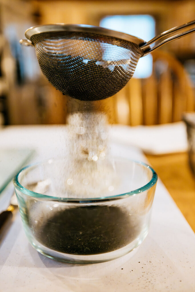 Sifting wildfire ash into a fine pigment powder
